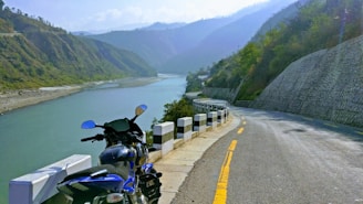 A scenic road winding through green hills, perfect for a motorcycle ride.