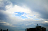 A cloud icon hovering above a cityscape, symbolizing cloud backup services.