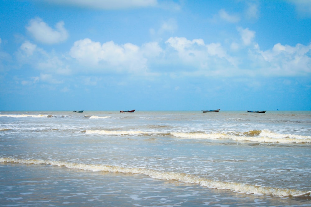 a group of boats floating on top of a body of water