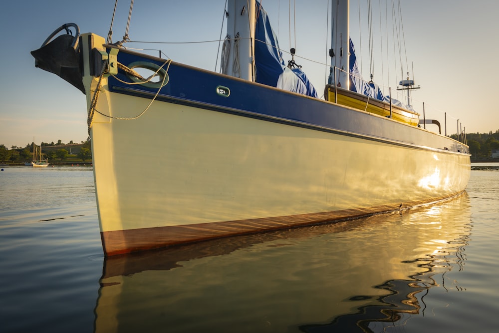 white and blue fishing boat