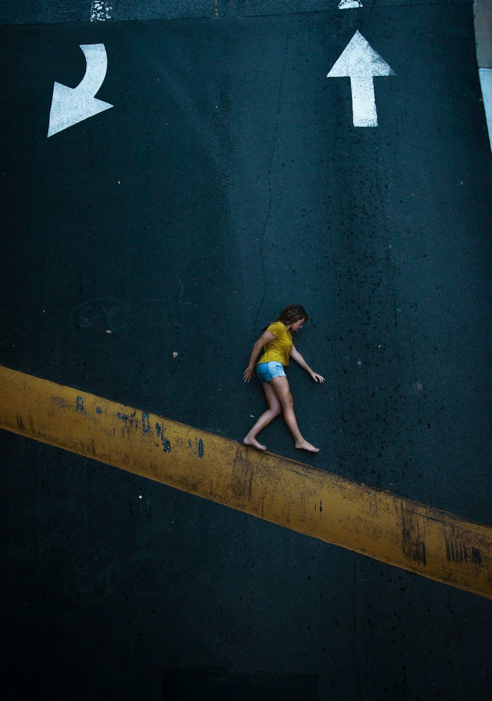 women lying on a road