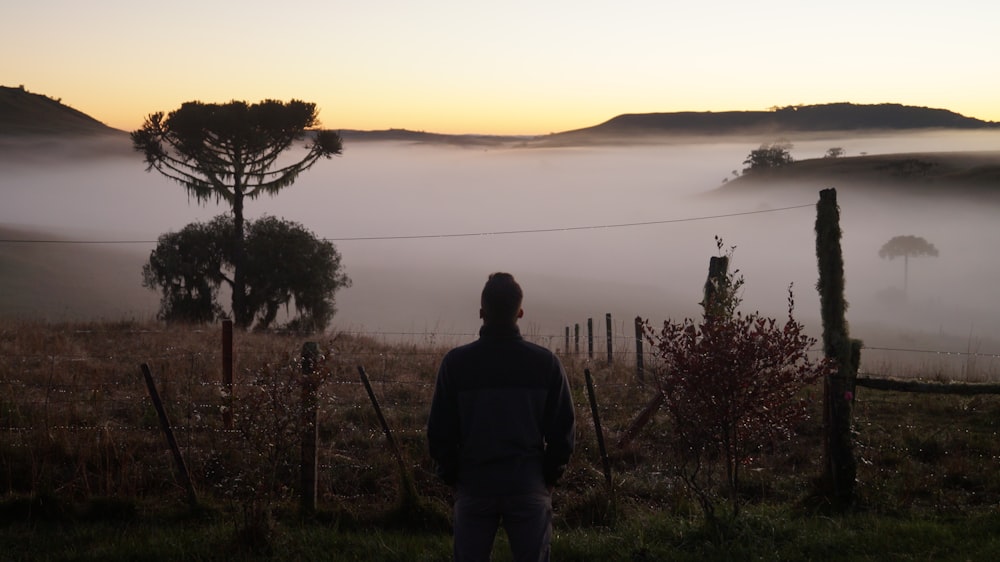 man standing near lake