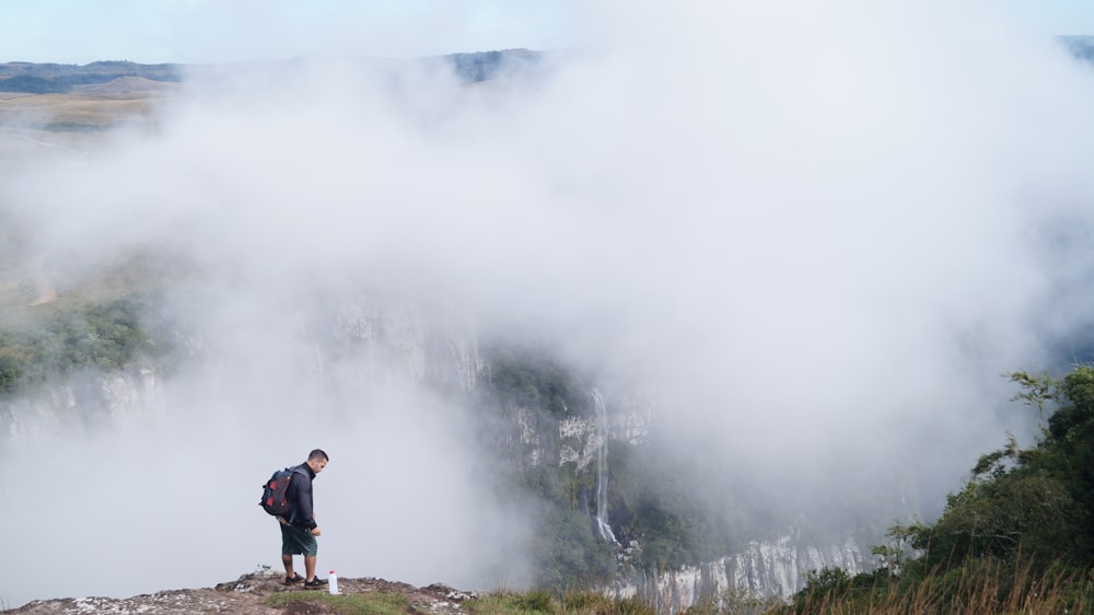 man standing on cliff