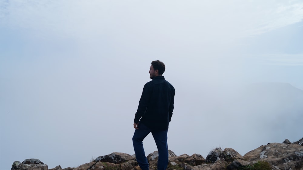 a man standing on top of a rocky mountain