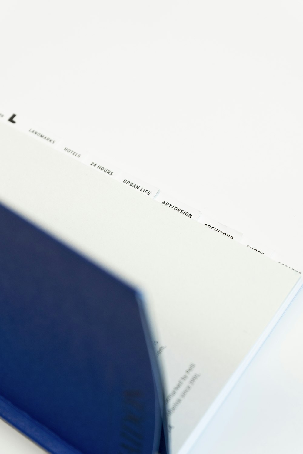 a close up of a blue book on a white surface