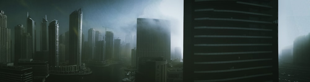 a city with tall buildings in the fog