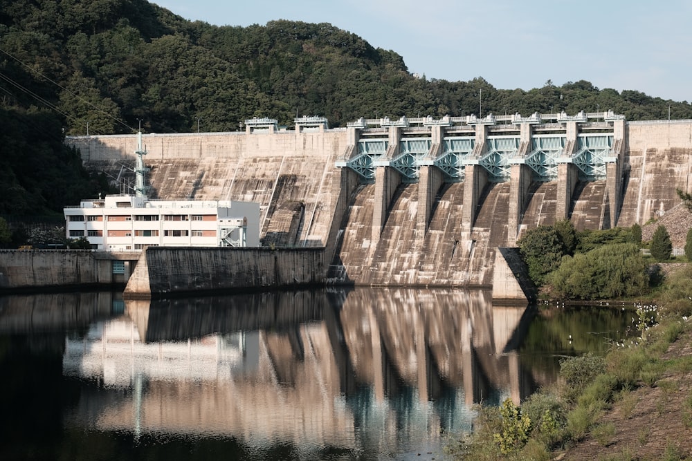 a large boat traveling down a river next to a dam