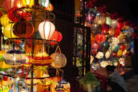 A cozy corner with folded traditional outfits stacked neatly next to a glowing lantern.