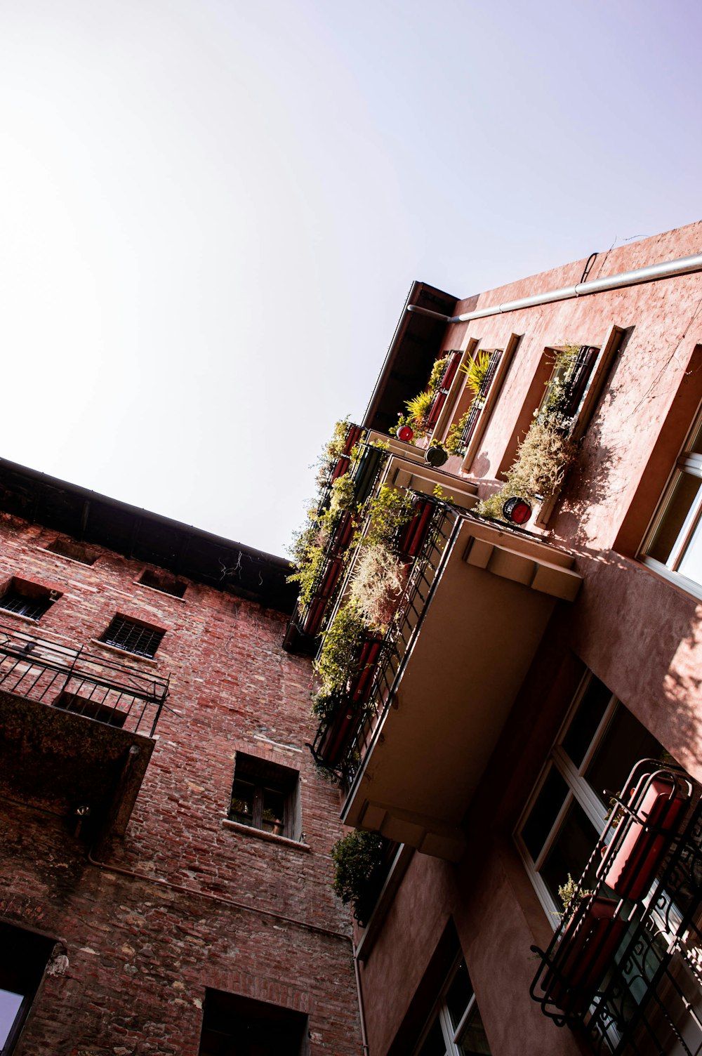 low-angle photo of brick building under white sky