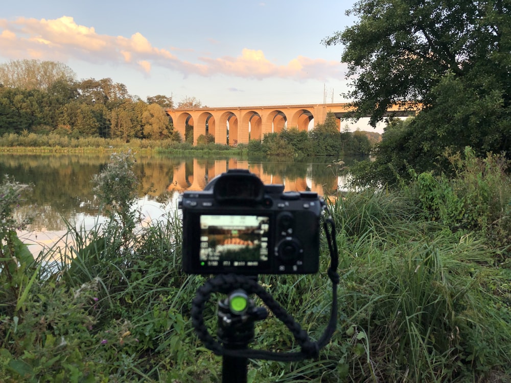 black digital camera capturing brown bridge