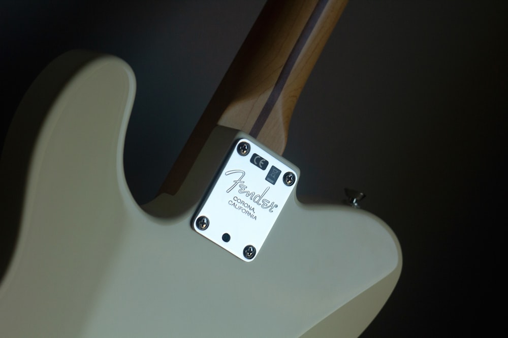 white Fender electric guitar