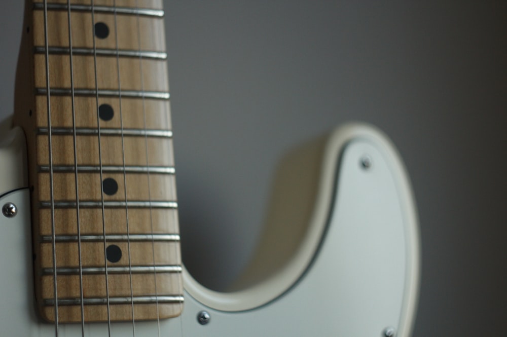 white and brown string instrument close-up photography