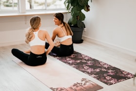 two women on yoga mats