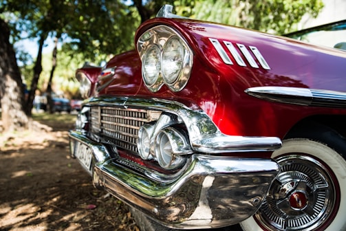 Behind-the-scenes shot of a photoshoot with a car influencer and a vintage muscle car.