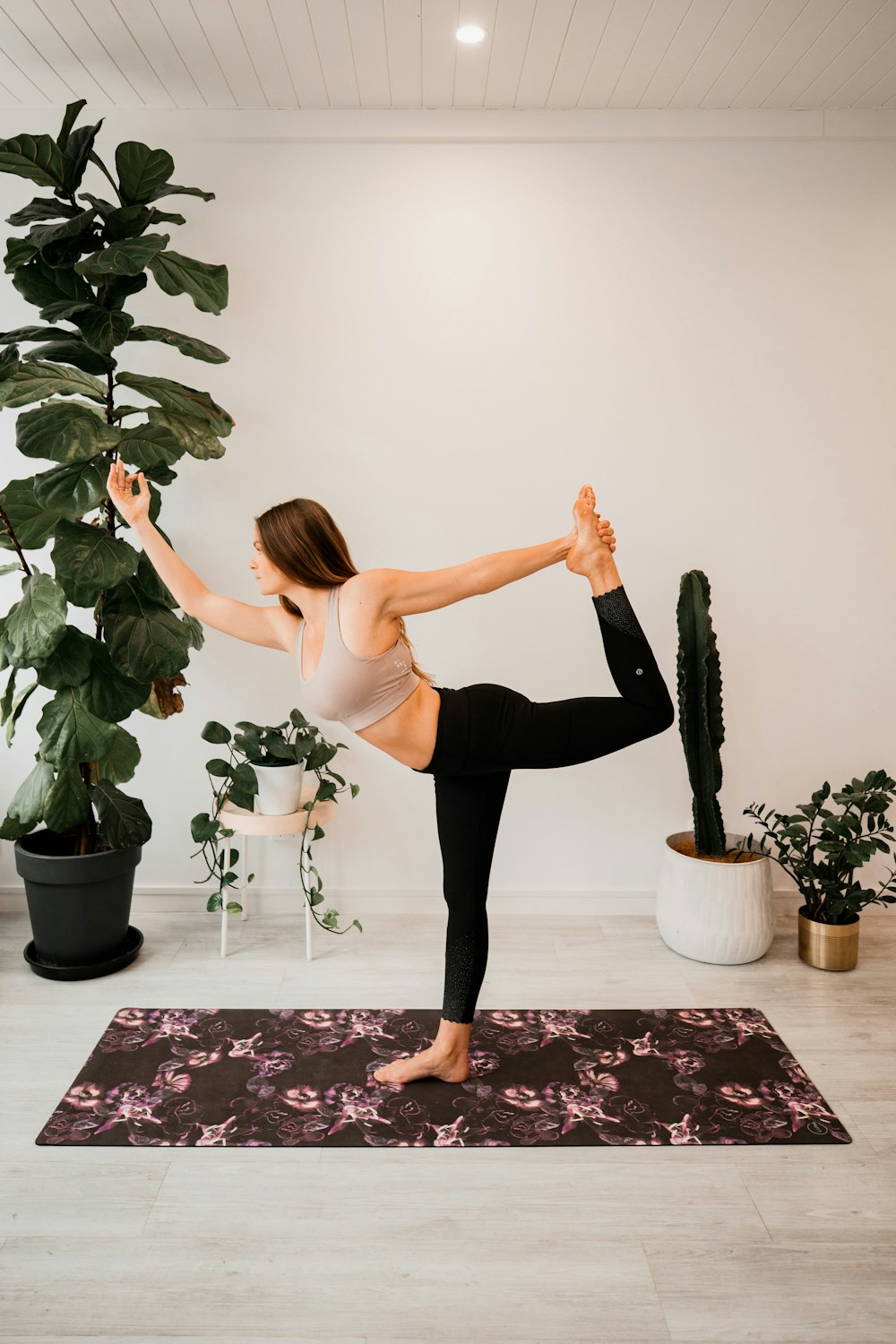 woman in beige sports bra and black leggings