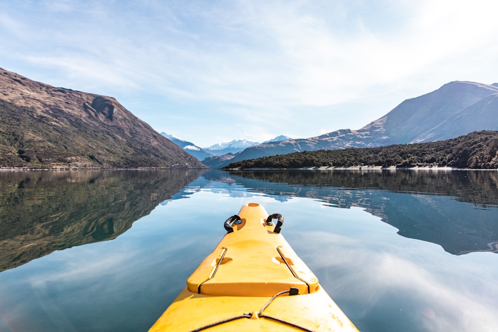 yellow kayak on calm body of water