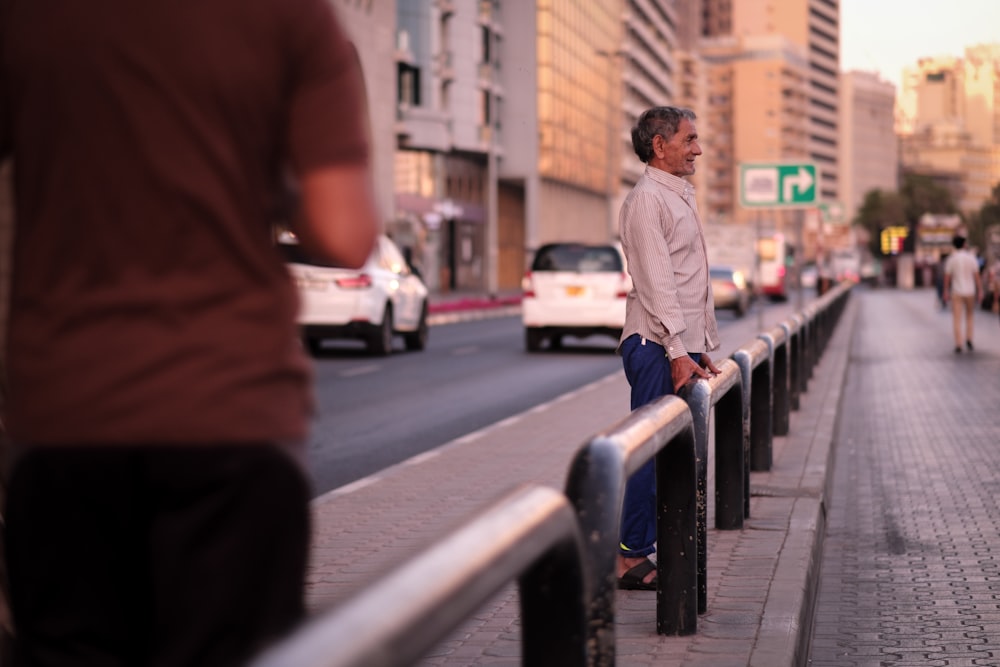 man standing in front of metal rail