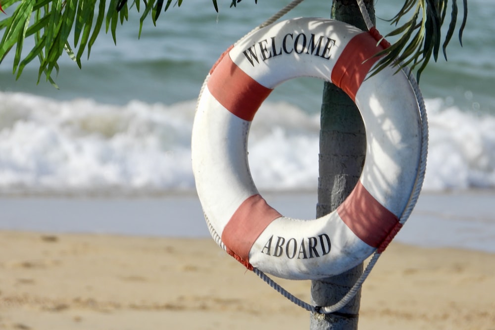 white and orange welcome aboard buoy