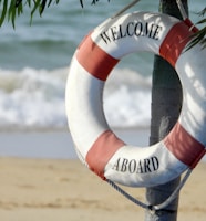 white and orange welcome aboard buoy