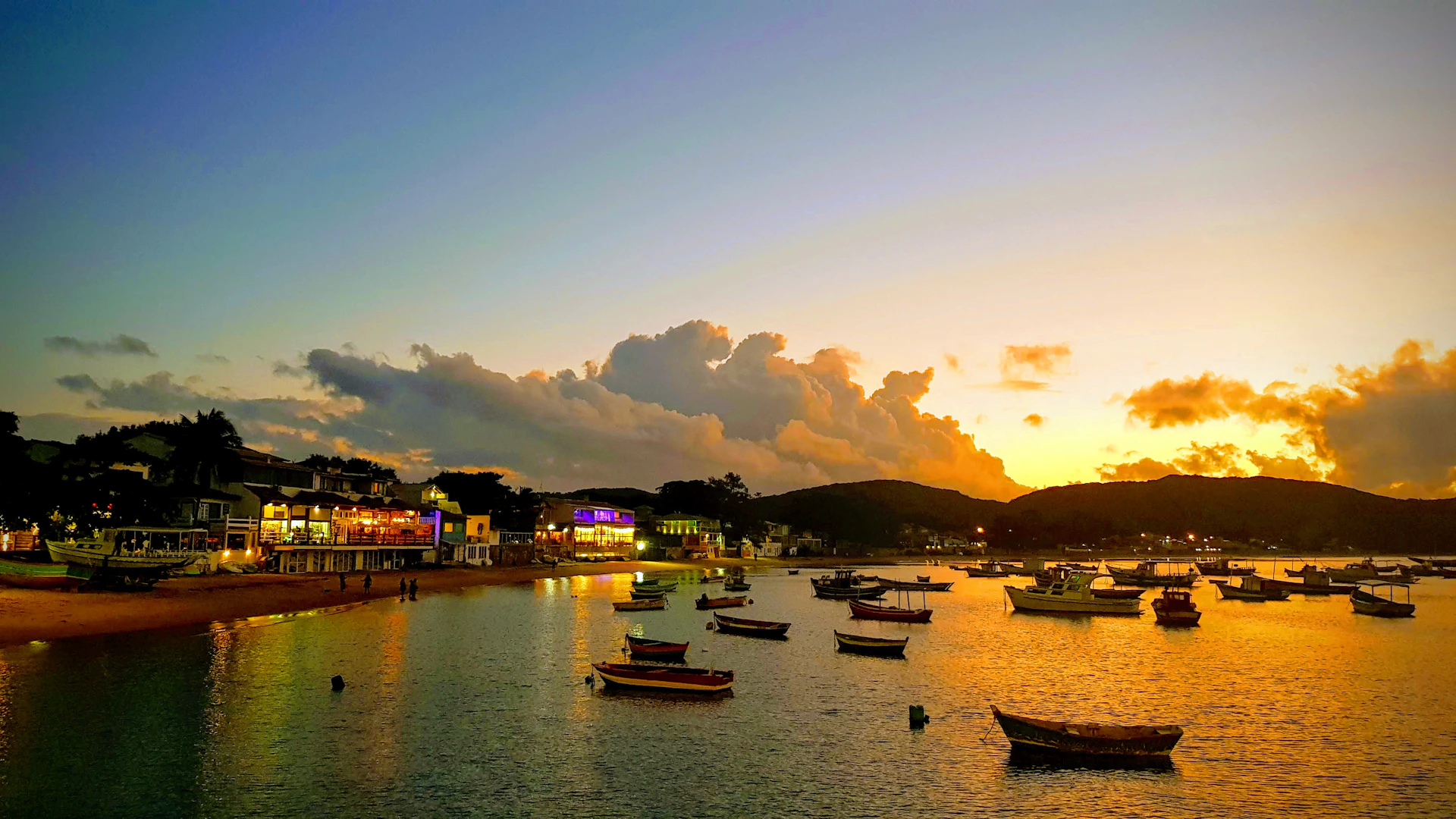 A serene sunset over a quiet coastal village, where colorful boats rest gently on the water, evoking a sense of peaceful belonging.