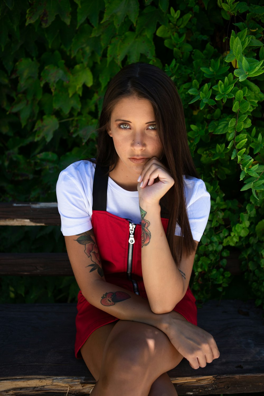 woman wearing red dress sitting on bench