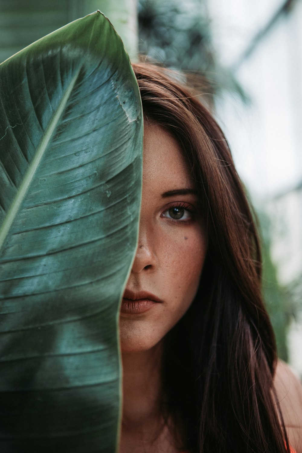 woman behind banana leaf