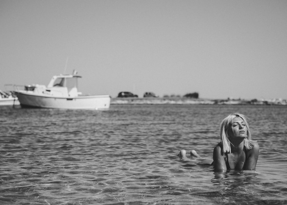 grayscale photography of woman in body of water