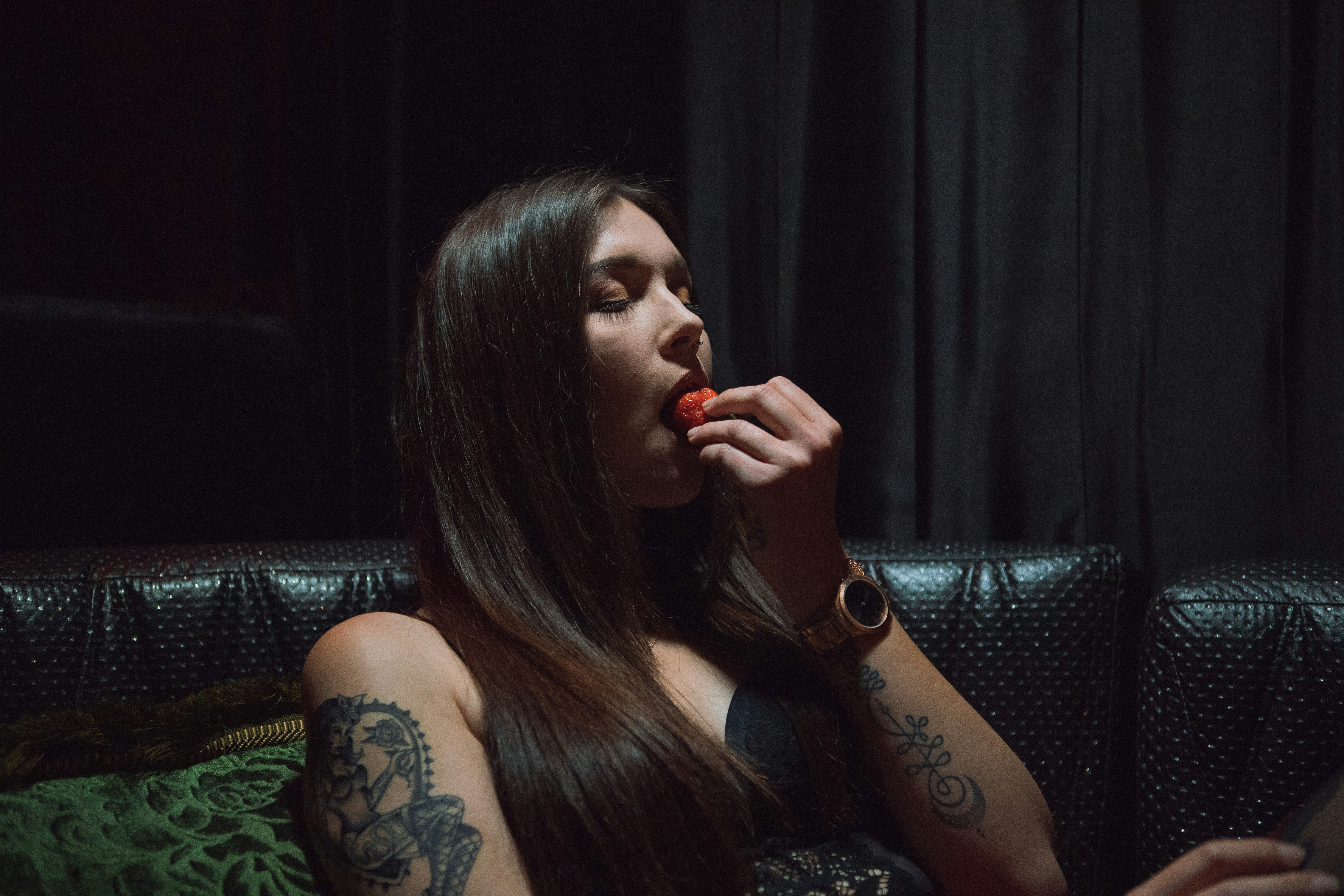 woman eating fruit inside room