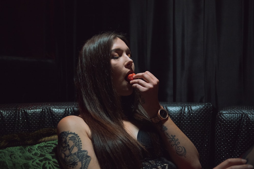 woman eating fruit inside room