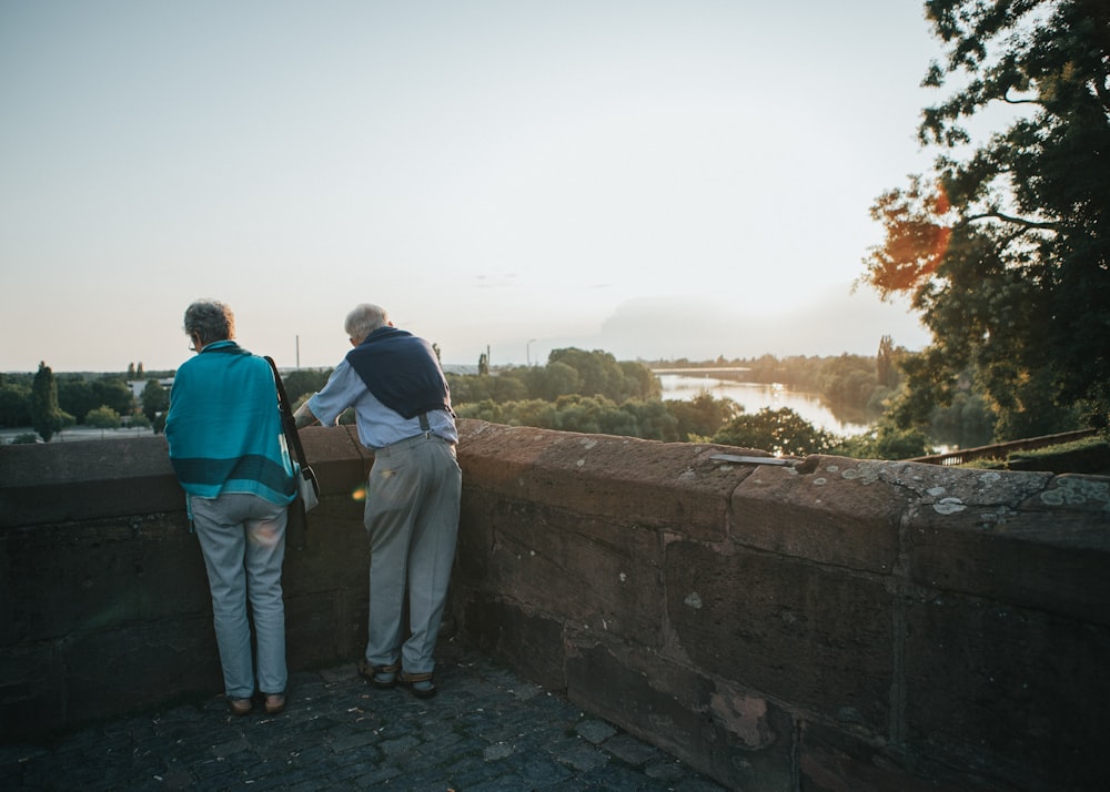 two persons standing near ledge