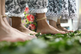 Close-up of feet moving gently on natural earth during a biodanza session at sunrise.