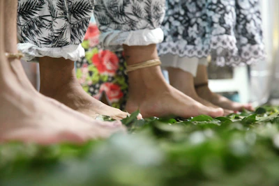 Close-up of feet moving gently on natural earth during a biodanza session at sunrise.