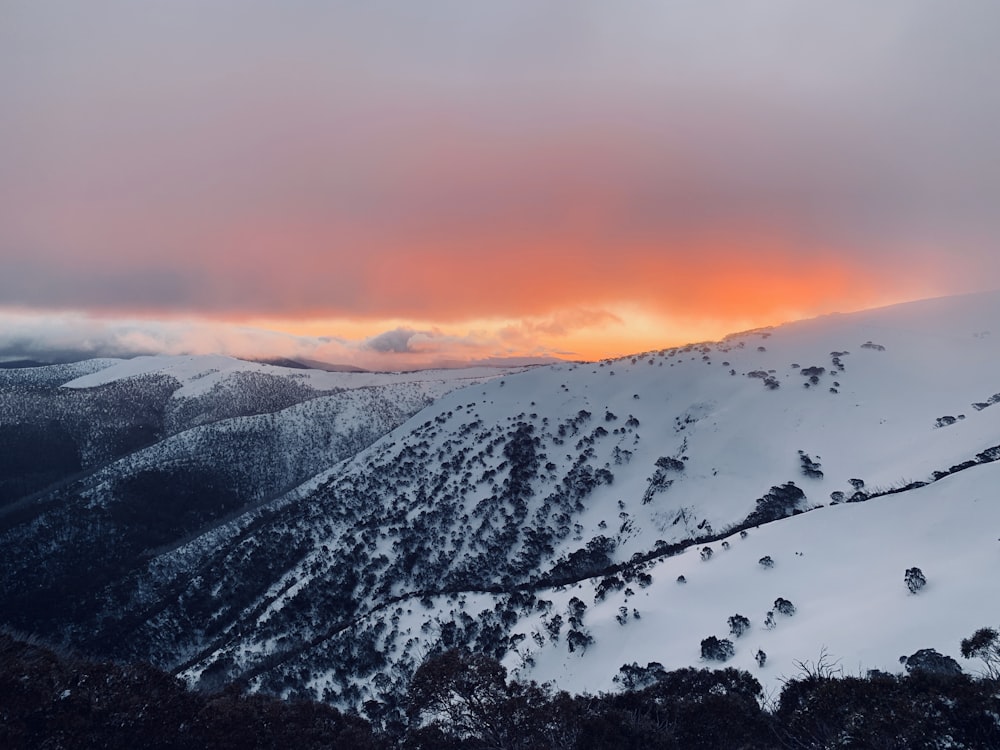 snow covered mountain and gray clouds