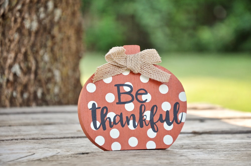 a wooden sign that says be grateful on it