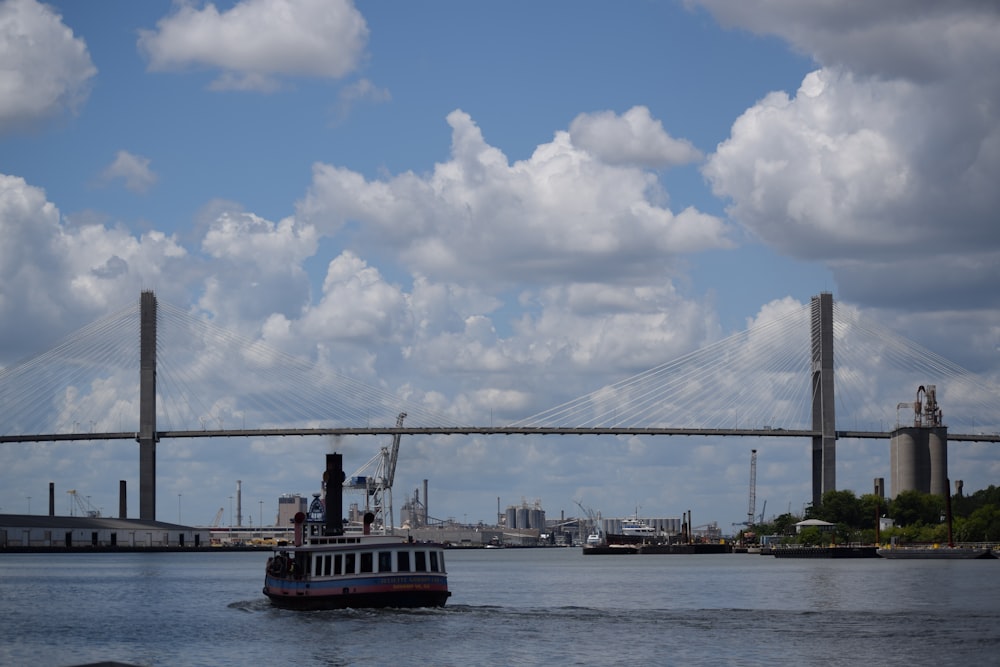 white boat near bridge