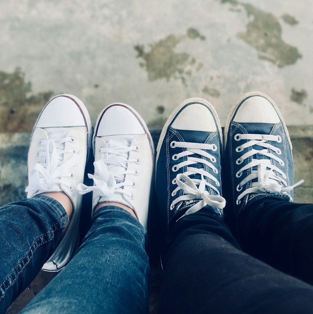 two pairs of white and blue low-top sneakers