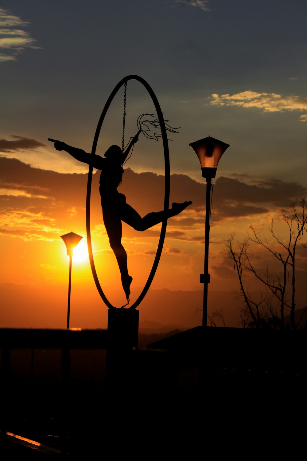 silhouette of woman near light post