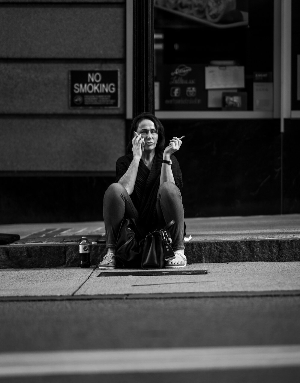 woman sitting near store