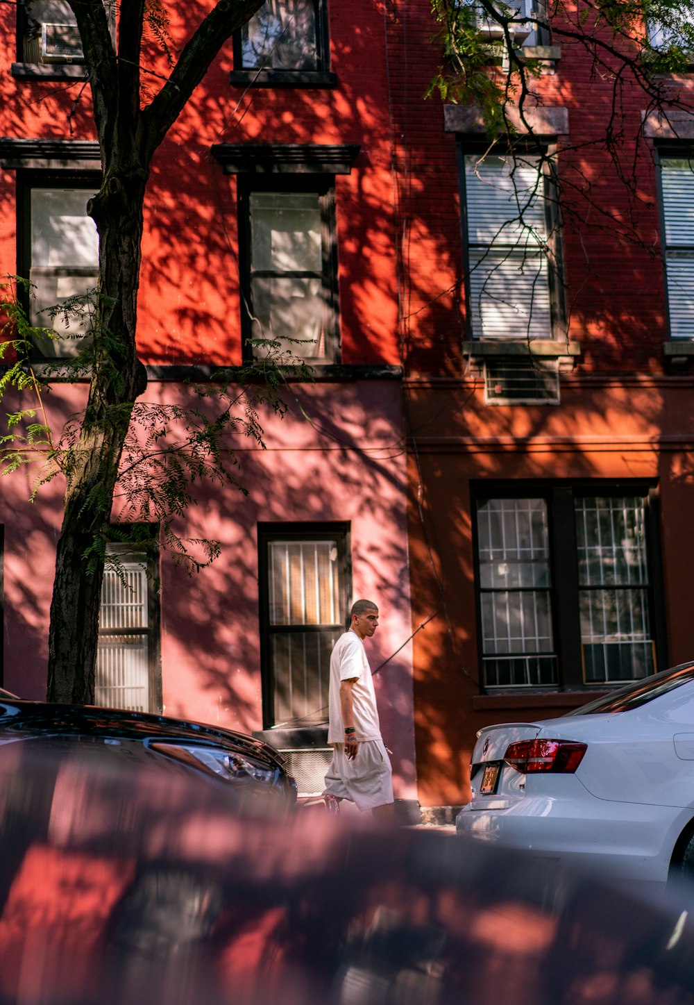 man walking on pathway near building during daytime