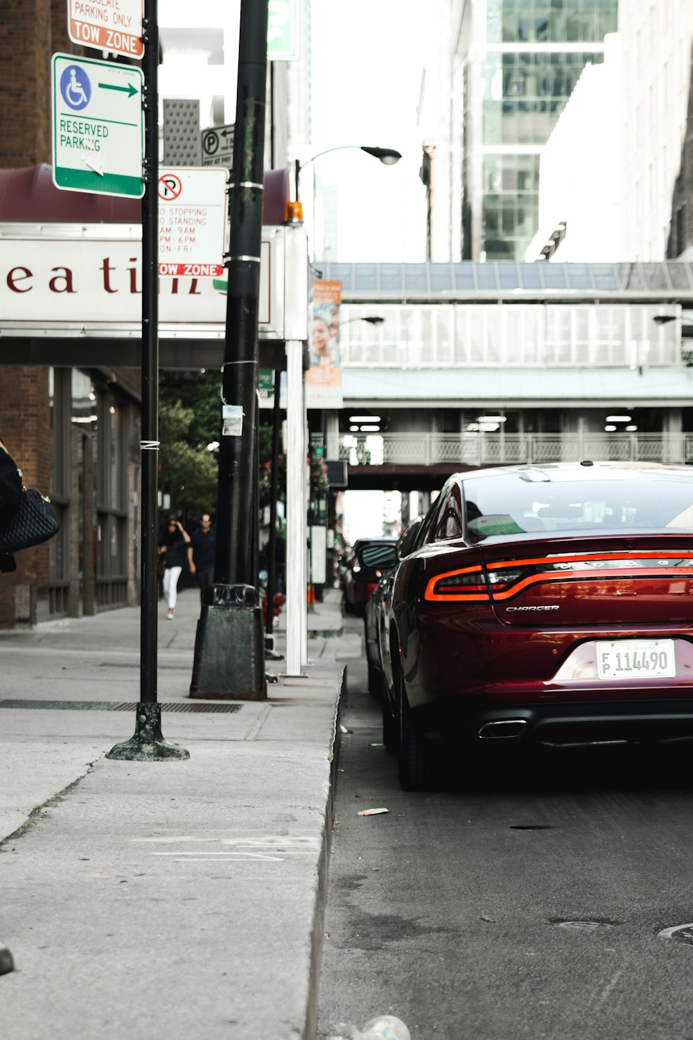 red vehicle parked near curb during daytime