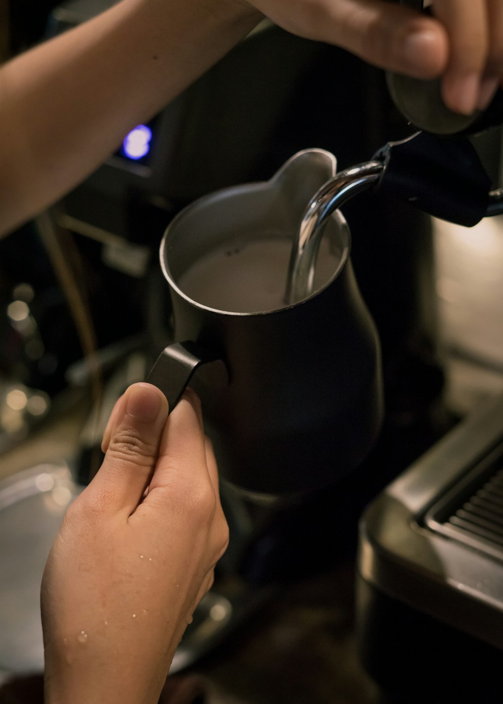 a person pours a cup of milk into a saucepan