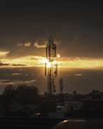 Retro radio tower silhouette against a sunset sky.