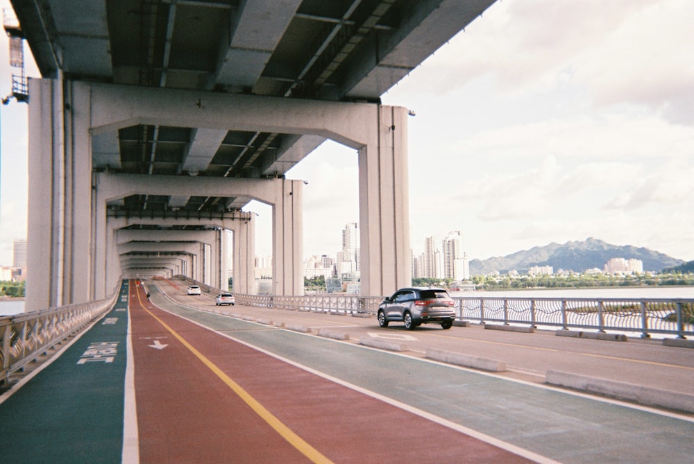 gray vehicle under bridge