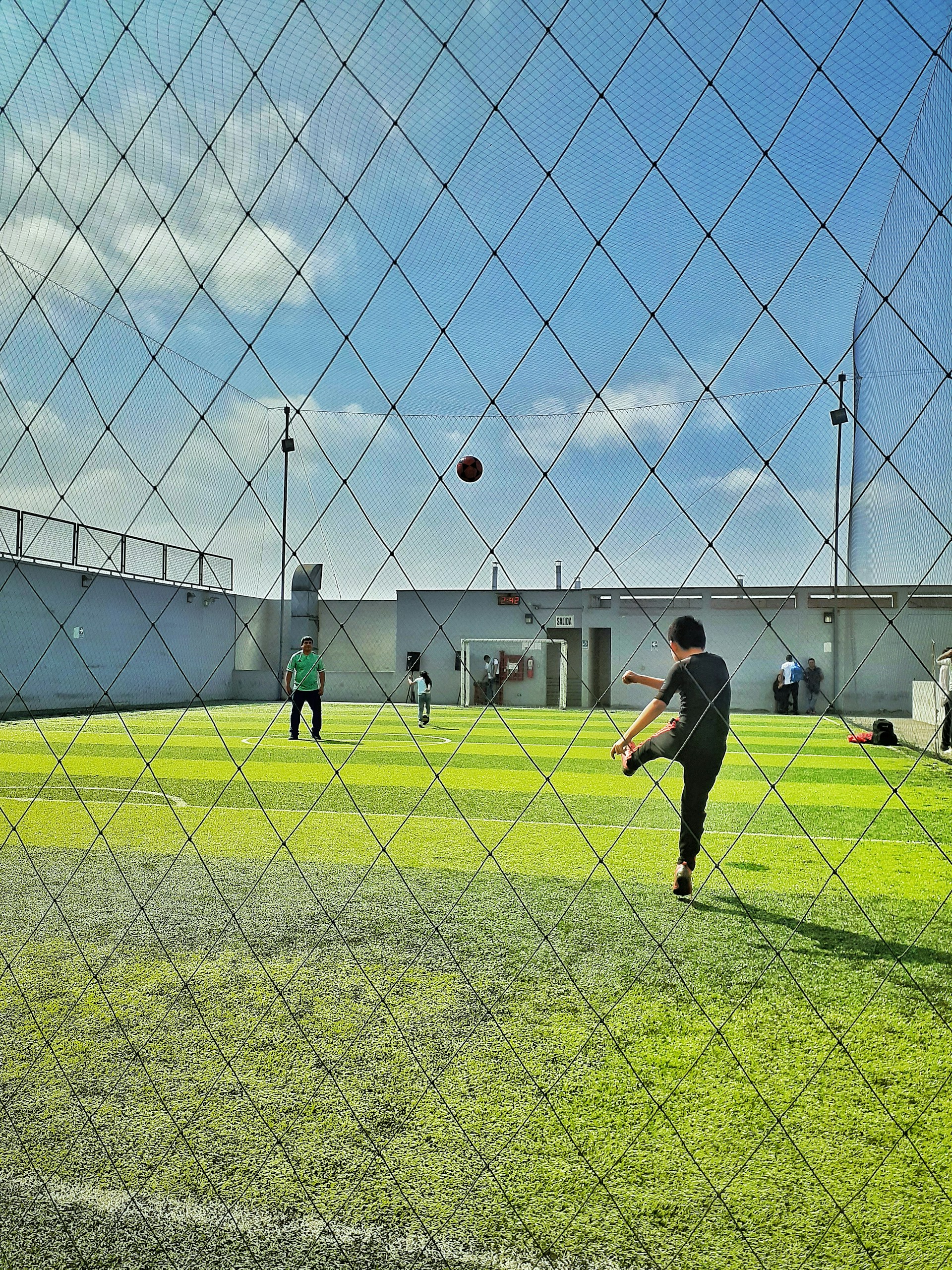 a man throwing a ball to another man on a baseball field