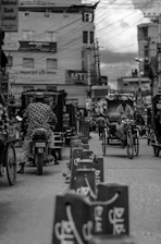 A vibrant street scene in Bangladesh featuring various electric vehicles charging and ready to drive.