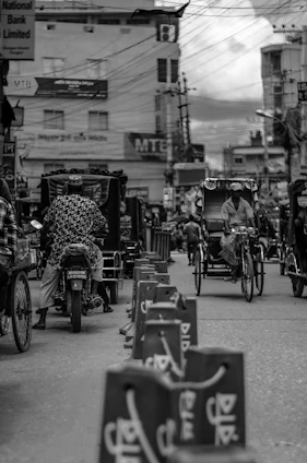 A vibrant street scene in Bangladesh featuring various electric vehicles charging and ready to drive.