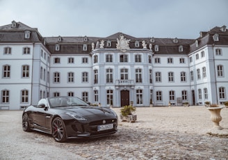 black sports coupe near building