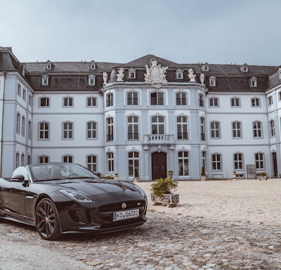 black sports coupe near building