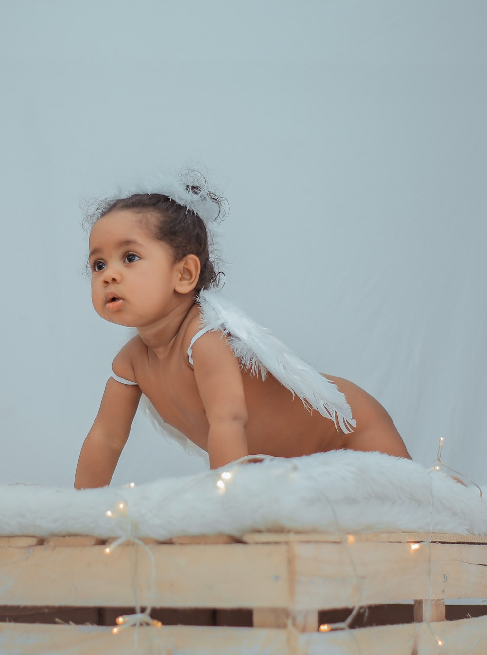 girl on top of bed with wings