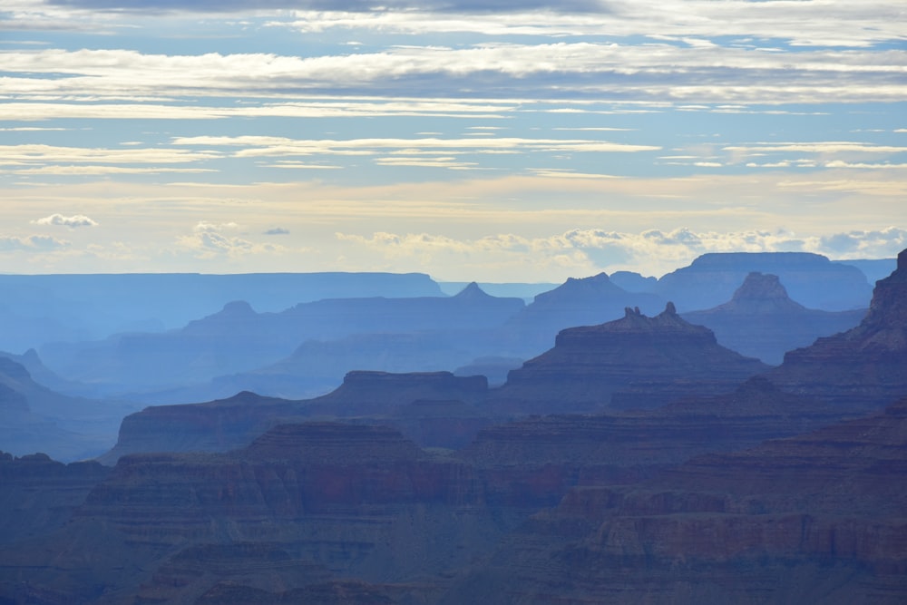 silhouette of mountains under white clouds